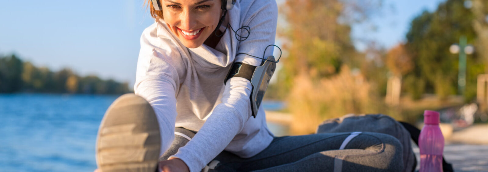 Beautiful Young Woman Working Out Outside By The Water