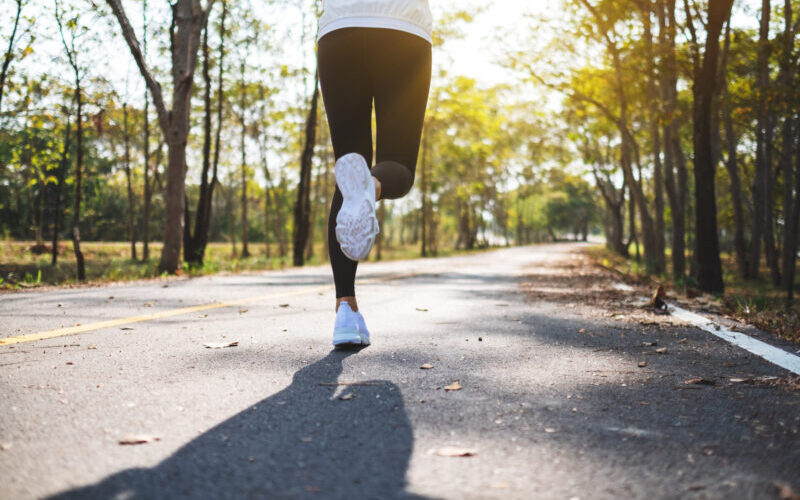 Rear View Image Of A Young Asian Woman Jogging In City Park In T